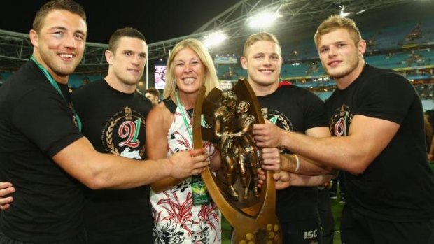 Happy days: The Burgess family poses with the trophy after the game.