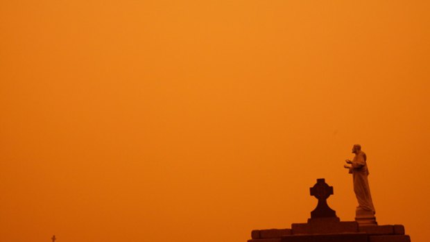 The dust storm leaves an eerie red hue over Waverley cemetery in Sydney. 