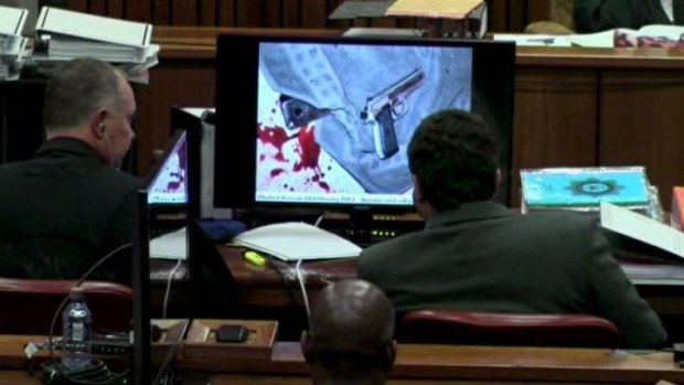 Photos shown to the court include one of the alleged murder weapon atop a bloodied towel.