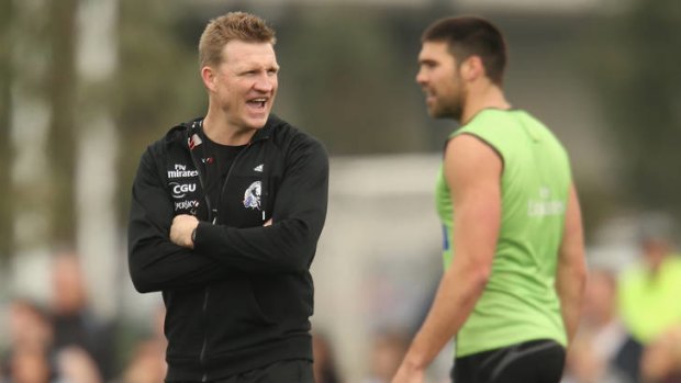 Collingwood coach Nathan Buckley with Chris Dawes at training.