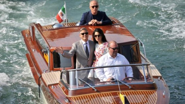 George Clooney and Amal Alamuddin cruise the Grand Canal on Sunday.