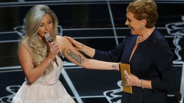 Singer Lady Gaga (left) pays tribute to Julie Andrews after performing songs from <i>The Sound of Music</i> at the 87th Academy Awards.