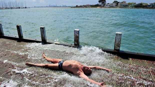 Iceberger John Locco takes advantage of a sunny break to cool off at Brighton Beach.
