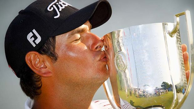 Daniel Popovic of Australia kisses the trophy after the final round of the Australian PGA.