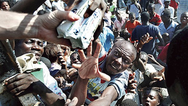 Intense ... Haitians scramble to receive aid from a food distribution truck. Increasing clashes over goods have reportedly claimed the life of one looter.