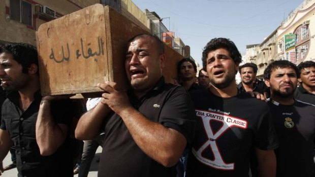 Relatives of Yunus Ismail, a victim who was killed by suicide bombers, carry his coffin during a funeral in Najaf, south of Baghdad.
