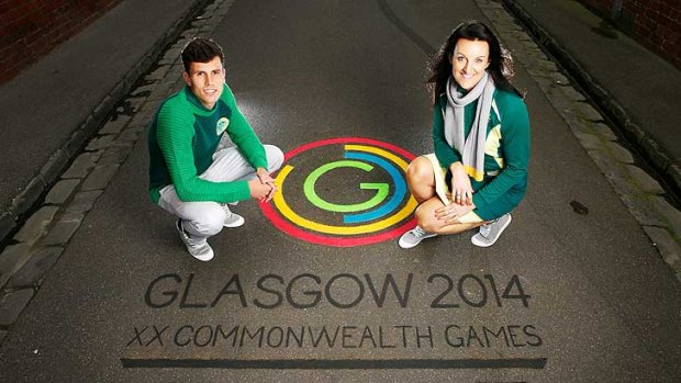 Netballer Bianca Chatfield and runner Jeff Riseley show off the Australian team uniform for the Glasgow Commonwealth Games.