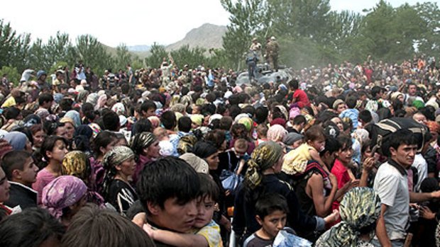 Thousands of ethnic Uzbeks gather near the border with southern Kyrgyzstan as the country slides into chaos. There are conflicting reports about whether they are being allowed to seek refuge inside Uzbekistan.