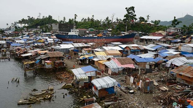 A cargo ship washed ashore at the height of super Typhoon Haiyan, lying amongst makeshift houses along the coastal area of Tacloban City, in central Philippines.