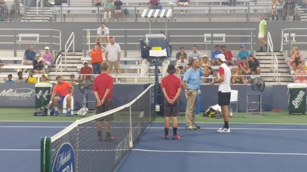 The chair umpire speaks with Thanasi Kokkinakis during his game against Ryan Harrison.