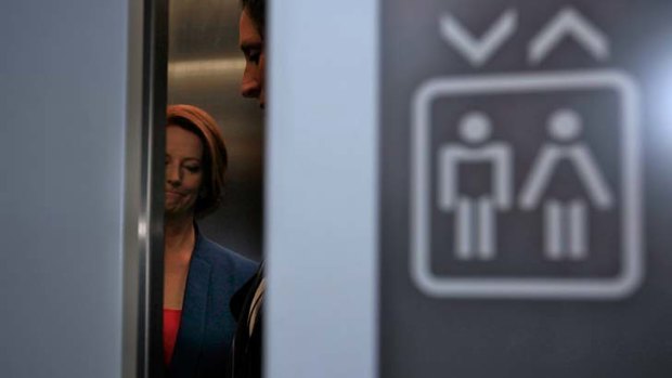 Julia Gillard walks out of a lift after attending the "Powerful Women Breakfast" at Old Parliament House on Tuesday.