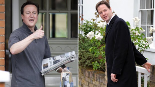 Hail-fellow-well-met... Conservative leader David Cameron, left, greets a neighbour yesterday morning and Liberal Democrat leader Nick Clegg leaves home yesterday.