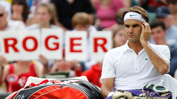 Roger that: Roger Federer takes a break during his second-round win over Fabio Fognini at Wimbledon.