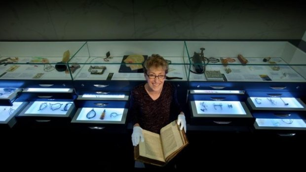 Dr Christine Ball at Melbourne's Geoffrey Kaye Museum of Anaesthetic History with a 1558 translation of Hippocrates' writings.