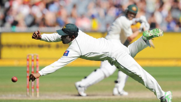 Pakistan's Umar Akmal dives in an attempt to stop a Shane Watson shot at the MCG yesterday. The Australian opener finished on 64 not out in his country's second innings.
