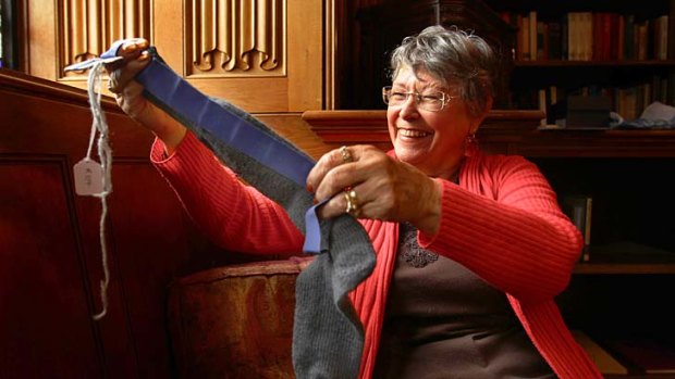 Duty calls &#8230; Janet Burningham inspects a sock knitted using a pattern probably similar to that used by women during WWI.