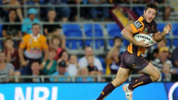 Somebody stop me: Ben Hunt streaks away for the Broncos' first try against the Titans. 