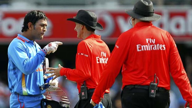 Indian skipper M.S. Dhoni jabs his finger in anger at umpire Billy Bowden after a contentious decision in a recent one-day international.