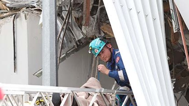 A woman is rescued from the Pyne Gould Guiness building after being trapped for over 24 hours.