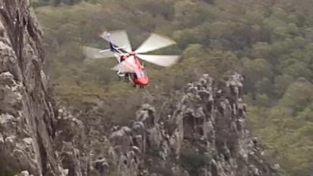 The EMQ Helicopter Rescue team airlifts an injured rock climber at Mt Maroon.