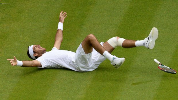 Theatre: Juan Martin Del Potro collapses after defeating David Ferrer in their quarter-final at Wimbledon.