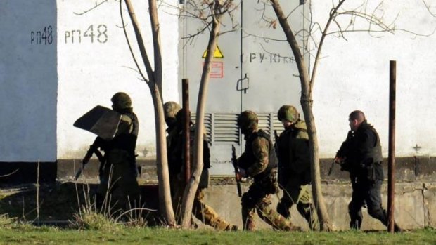 Armed Russian forces take part in a military operation at a Ukrainian military base in Simferopol. 