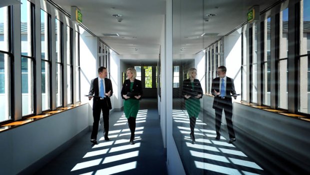 Chief Minister Katy Gallagher walks with Green MLA Shane Rattenbury on their way to sign an agreement to form government at the ACT Legislative Assembly.