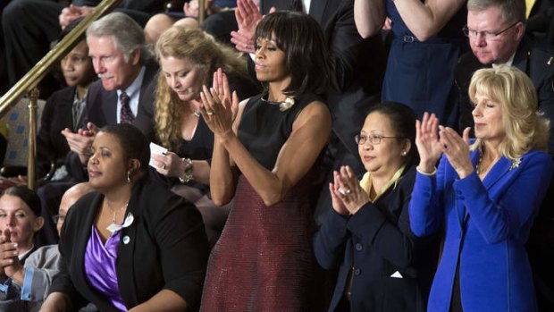 First Lady Michelle Obama applauds.