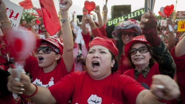 Pro-government red shirt supporters react during a speech in Bangkok.