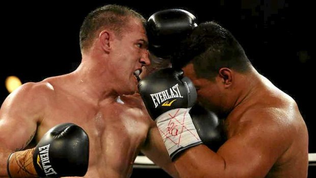 Floored: Paul Gallen grapples with Herman Purcell during the heavyweight bout.