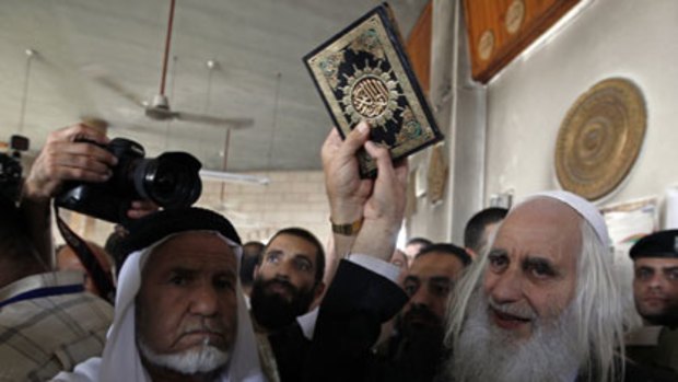 Solidarity ... Menachem Froman holds a Koran at the Beit Fajjar mosque.