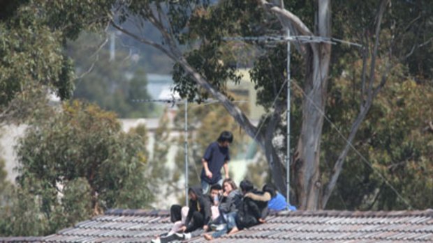 Warning ... Chinese detainees, including a pregnant woman, yesterday threatened to jump off a roof at the Villawood centre.