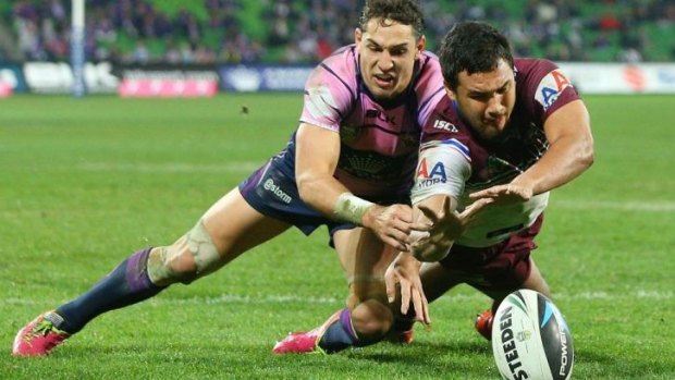 Peta Hiku battles with Billy Slater in a bid to ground the ball  for a try.