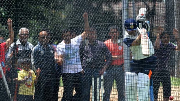My hero &#8230; fans watch on as master craftsman Sachin Tendulkar practises his back-foot defence in the nets at Manuka Oval. He steps out for India against the Chairman's XI today.