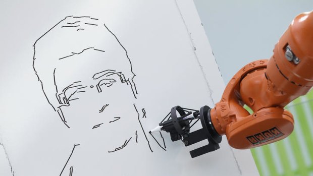 A robot draws a portrait from a photograph.
