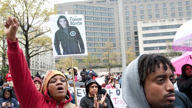 National debate ... a Hoodies on the Hill demonstration on Capitol Hill; one banner has a picture of President Obama in a hoodie and reads ''I am Trayvon Martin''.