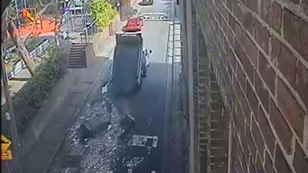 Escaped: CCTV images show the Daihatsu Delta dumping the asbestos on Wattle Lane in Ultimo. The number plate was covered with cloth.