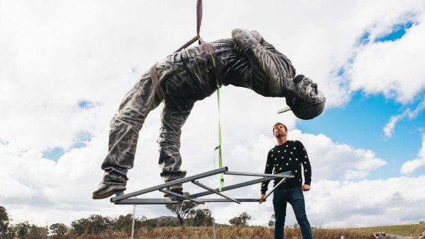 Louis Pratt oversees the installation of his work, Backwards Attitude, at the National Arboretum Canberra.