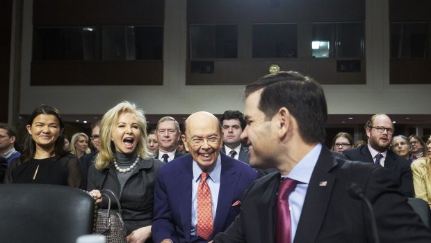 Wilbur Ross and his wife Hilary Geary smile as Senator Marco Rubio, a Republican from Florida, right, introduces Ross during Ross'  confirmation hearing in Washington.