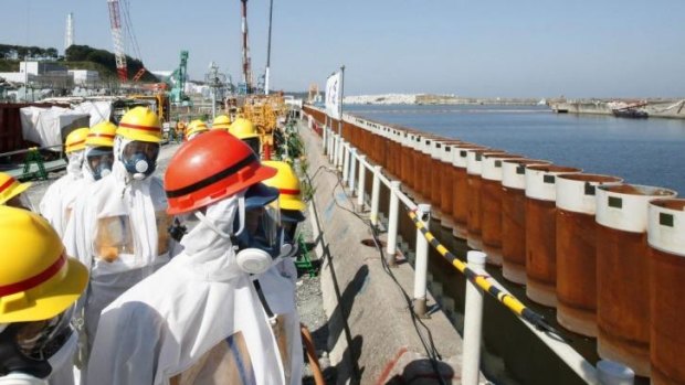 Wall hits a snag: Japanese PM Shinzo Abe looks at the wall along the coast of Tokyo Electric's Fukushima nuclear power plant in 2013.