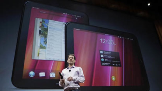 Palm CEO Jon Rubinstein shows off the new TouchPad tablet during a Palm/Hewlett Packard event.