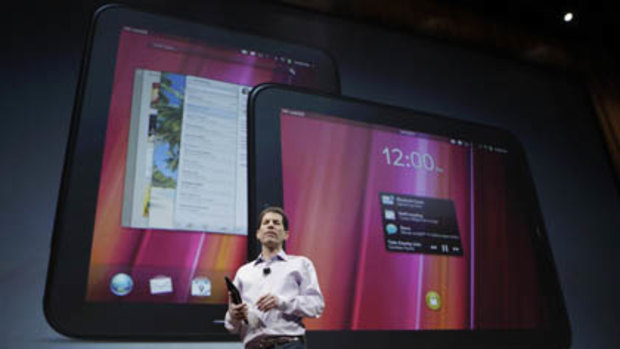 Palm CEO Jon Rubinstein shows off the new TouchPad tablet during a Palm/Hewlett Packard event.