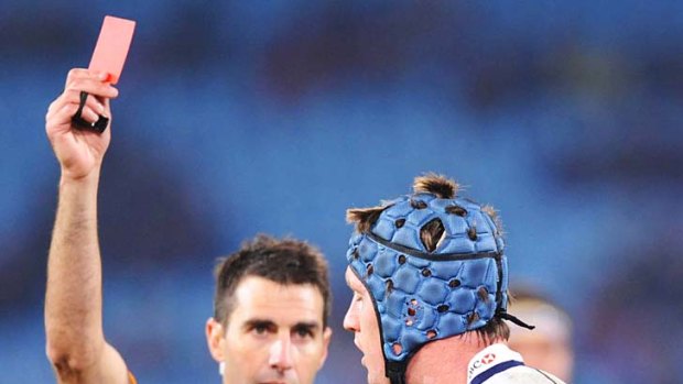 Referee Craig Joubert shows a red card to Pat O'Connor of the Waratahs during a Super Rugby match between the Bulls and the Waratahs at Loftus Versfeld last year. This year there will be an additional card, the white card, to be used by off-field officials.