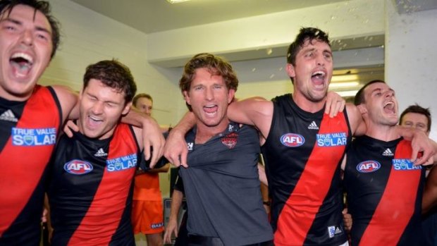 In happier times: James Hird celebrates with his players after a narrow win.