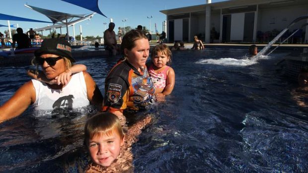 Cooling off: Shane Weatherall, 5, with his nan Marlene Wood (left) and his mother Lee Stothard holding his sister