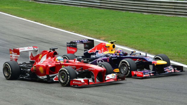 Dramatic duel: Ferrari's Spanish driver Fernando Alonso overtakes Red Bull Racing's Mark Webber.