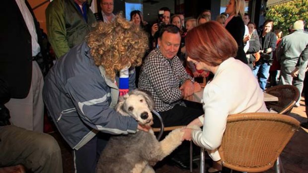 Shaking off a disappointing election result ...  Julia Gillard meets Sunny, an English sheepdog,  while having breakfast with her partner Tim Mathieson in Altona yesterday.