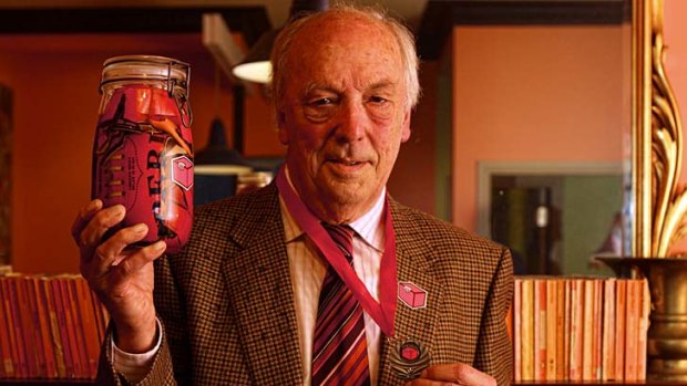 Brian Troy with his Wilkie medal and pickled football.