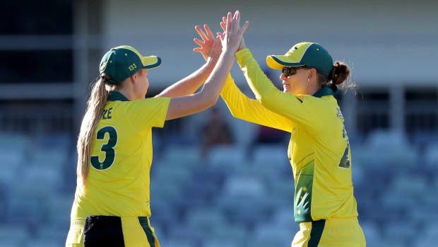 One up: Lauren Cheatle (left) celebrates with Jess Jonassen after Australia won the opening women's ODI series match against New Zealand at the WACA ground in Perth.