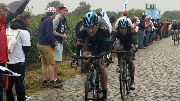 The chase: Geraint Thomas helps Richie Porte (R) during Wednesday's fifth stage,